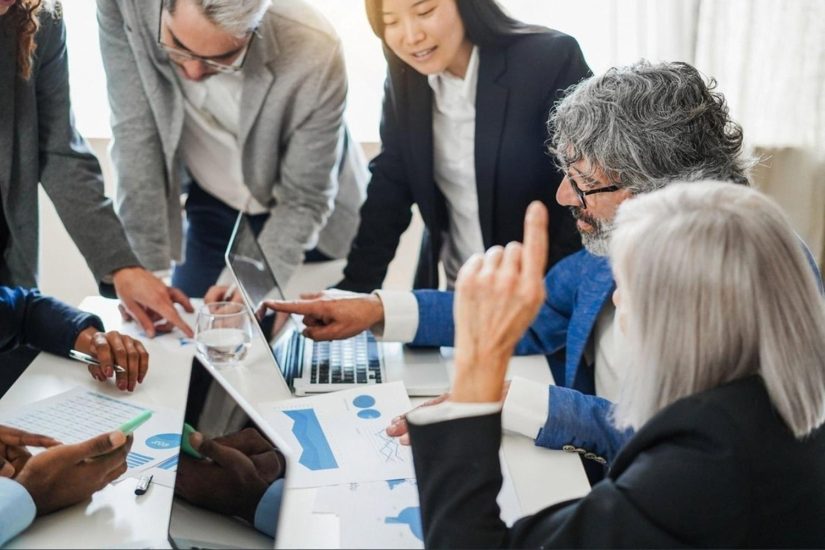 Executives analysing financial reports and fraud risk indicators in a boardroom